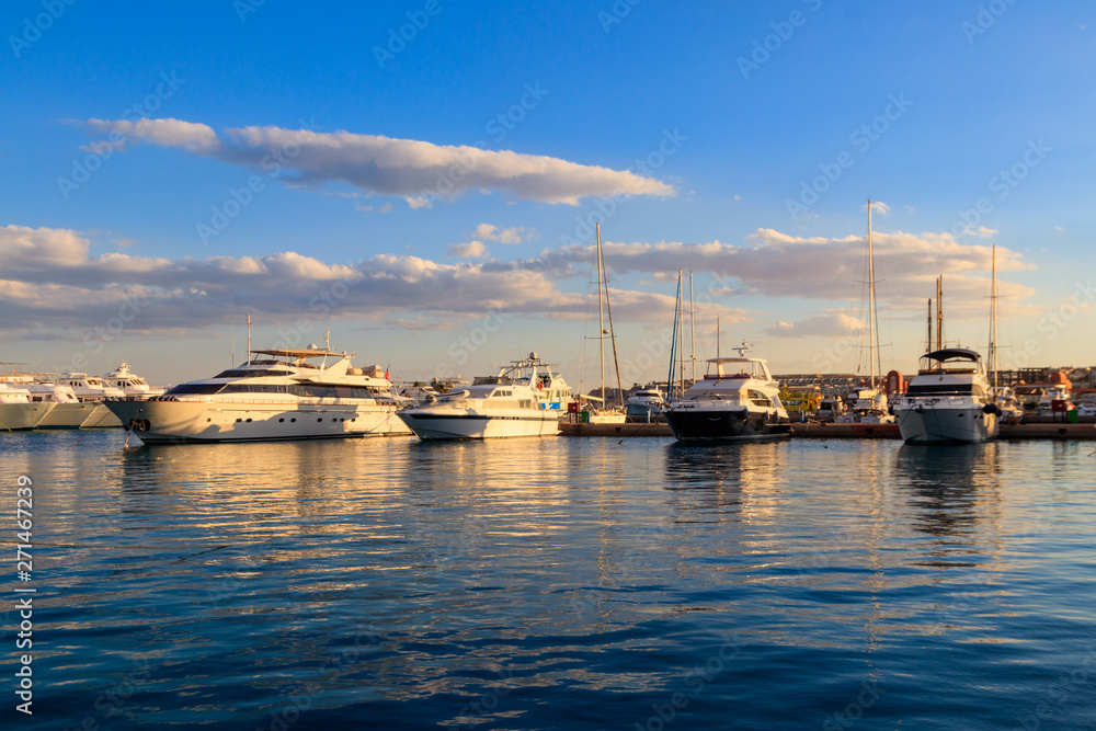 White yachts in the sea harbor of Hurghada, Egypt. Port with tourist boats on the Red Sea