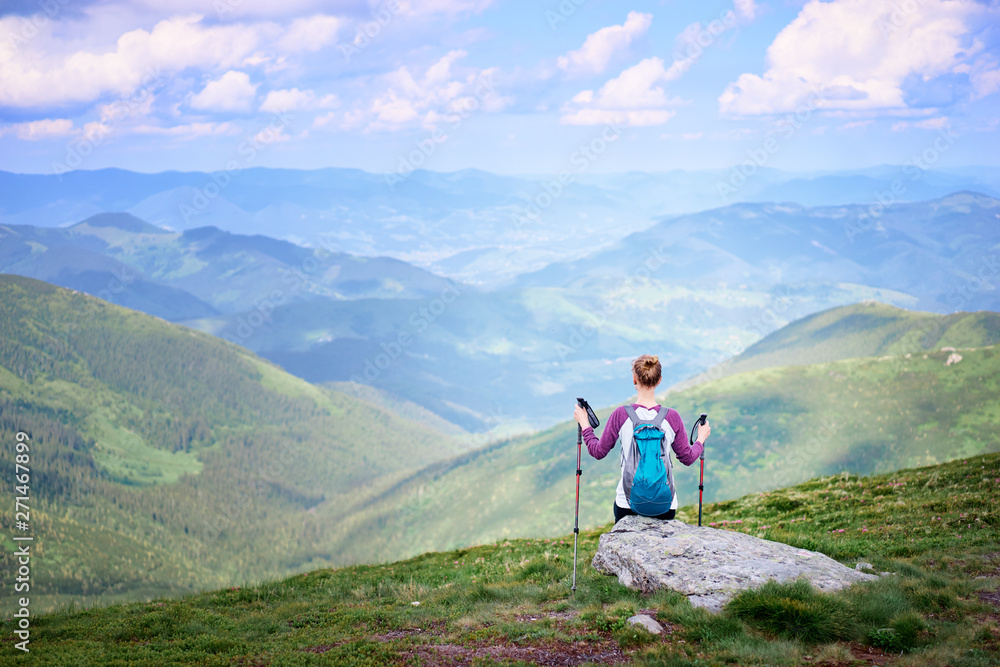 Obraz premium Active lifestyle. Traveling, hiking and trekking concept. Young woman with backpack in the Carpathian mountains.