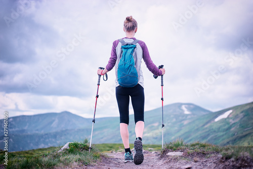 Active lifestyle. Traveling, hiking and trekking concept. Young woman with backpack in the Carpathian mountains.