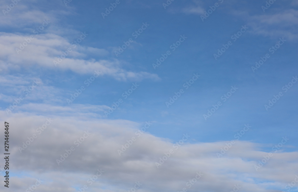 horizontal blue sky with white clouds