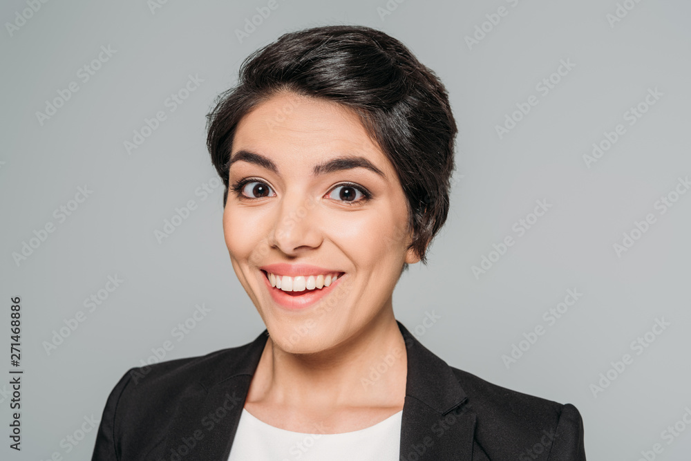 portrait of beautiful mixed race businesswoman smiling at camera isolated on grey portrait of beautiful mixed race businesswoman smiling at camera isolated on grey