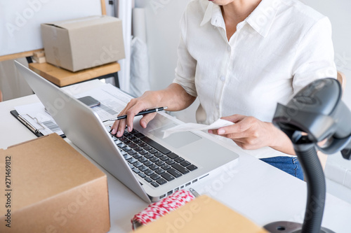 Shipment Online Sales, Small business or SME entrepreneur owner delivery service and working packing box, business owner working checking order to confirm before sending customer in post office