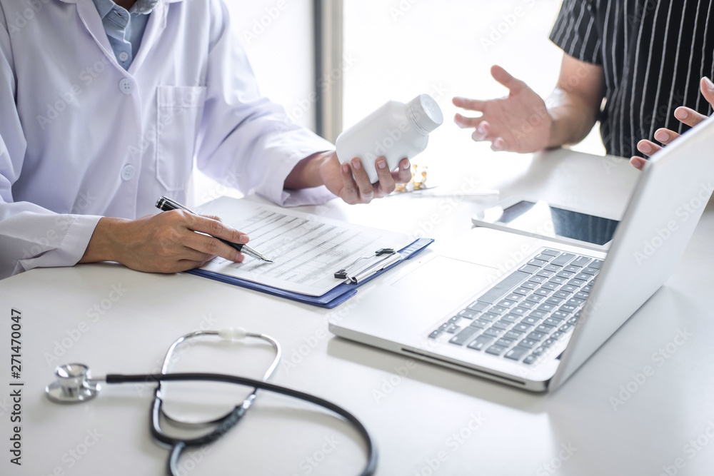 Doctor consulting patient discussing something symptom of disease and recommend treatment methods, presenting results on report and prescription, Medicine and health care concept Doctor consulting patient discussing something symptom of disease and recommend treatment methods, presenting results on report and prescription, Medicine and health care concept