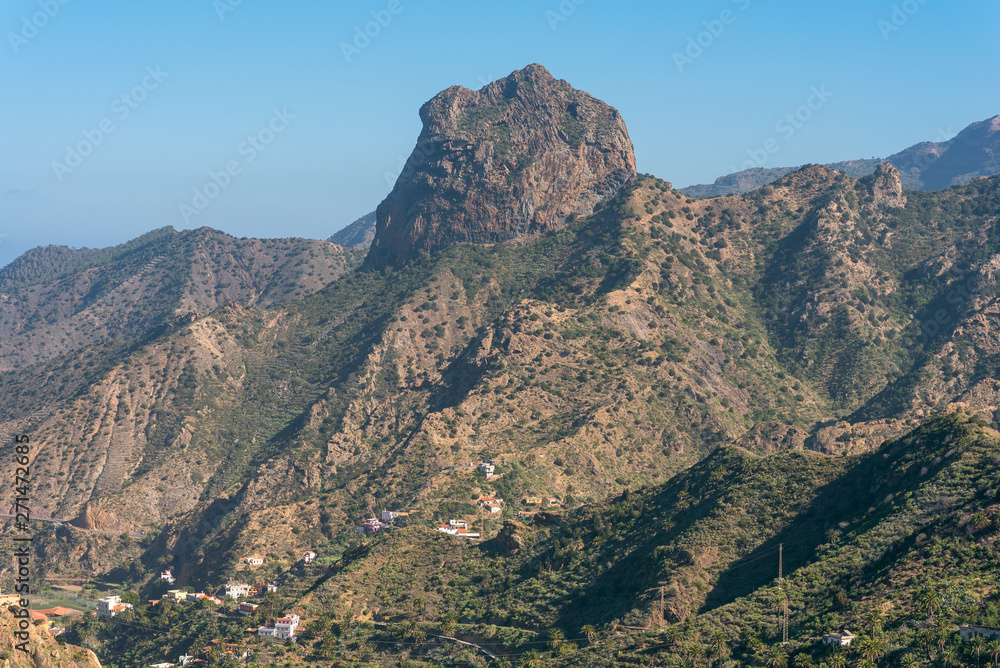 Volcanic plug in Vallehermoso what means the beautiful valley in english. View to the Roque Cano, a famous volcanic neck on the north side of La Gomera