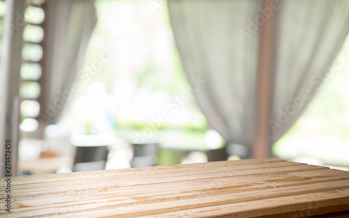 Empty of wood table top on blur of curtain with window view green from tree garden background.For montage product display or design key visual layout © kishivan