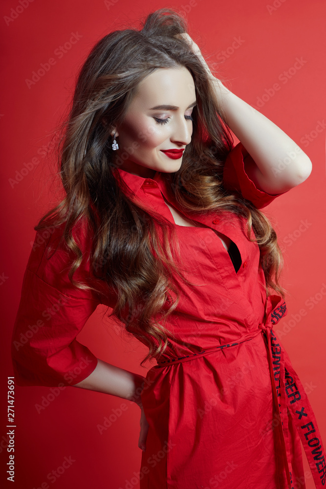 Fototapeta premium Romantic woman with long blonde hair in red dress, smooth clean skin