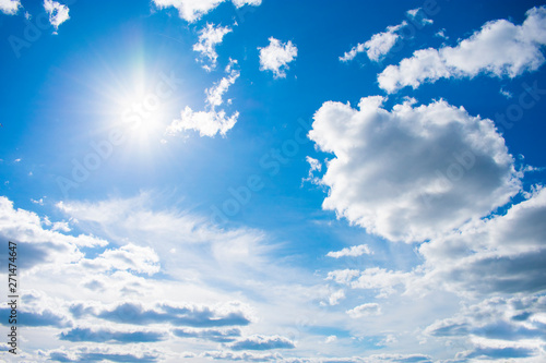 Cloudy sky with natural sun flare. Clouds. Free sky. Background.