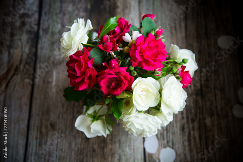 bouquet of beautiful red and white roses on a wooden © Peredniankina