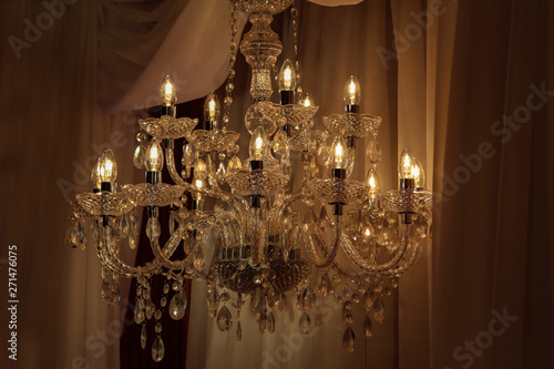 Beautiful electric chandelier on a dark background © leomalsam