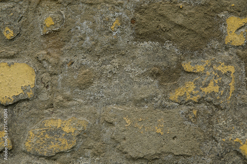 Background of yellow and gray grungy brick wall