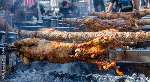Fototapeta Naklejka Na Ścianę i Meble -  Greek Easter custom. Kokoretsi, kokorec and lamb, sheep, kid grilling on spits over charcoals fire.
