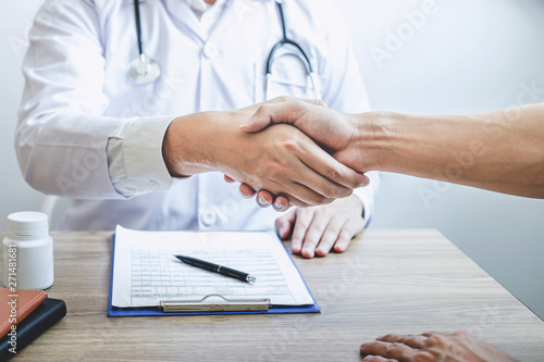 Doctor having shaking hands to congrats with patient after recommend treatment while discussing explaining his symptoms and counsel diagnosis health, healthcare and assistance concept