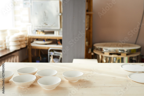Background image of traditional pottery shop interior lit by sunlight, copy space