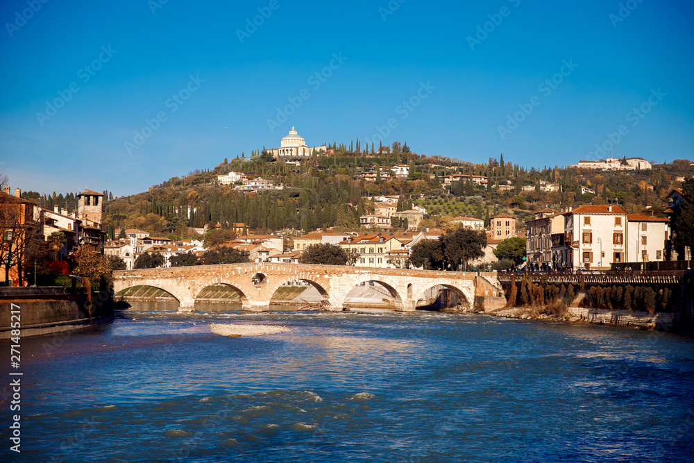 Verona, Italy. River with old bridges, stone houses on hill