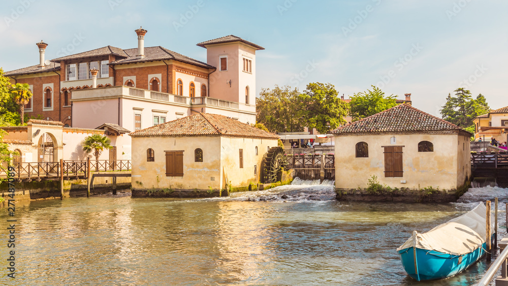 Cityscape of Portogruaro in Veneto Italy with lemene river, tower and mills