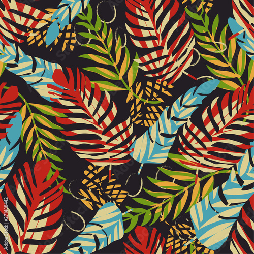 Bright seamless tropical pattern with leaves and flowers on a dark background. Vector design. Jungle print. Textiles and printing. Floral background.