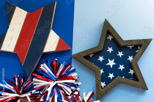 Festive Fourth of July flatlay concept with wooden stars, and shiny pom poms, useful for patrotic USA themed backgrounds photo