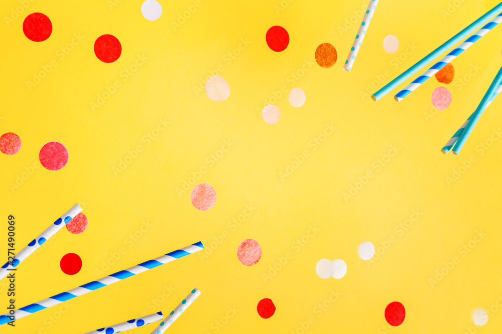Fototapeta premium Frame of colorful drinking straws for beverage and colored confetti on a bright background. Birthday festive party cheerful mockup background .
