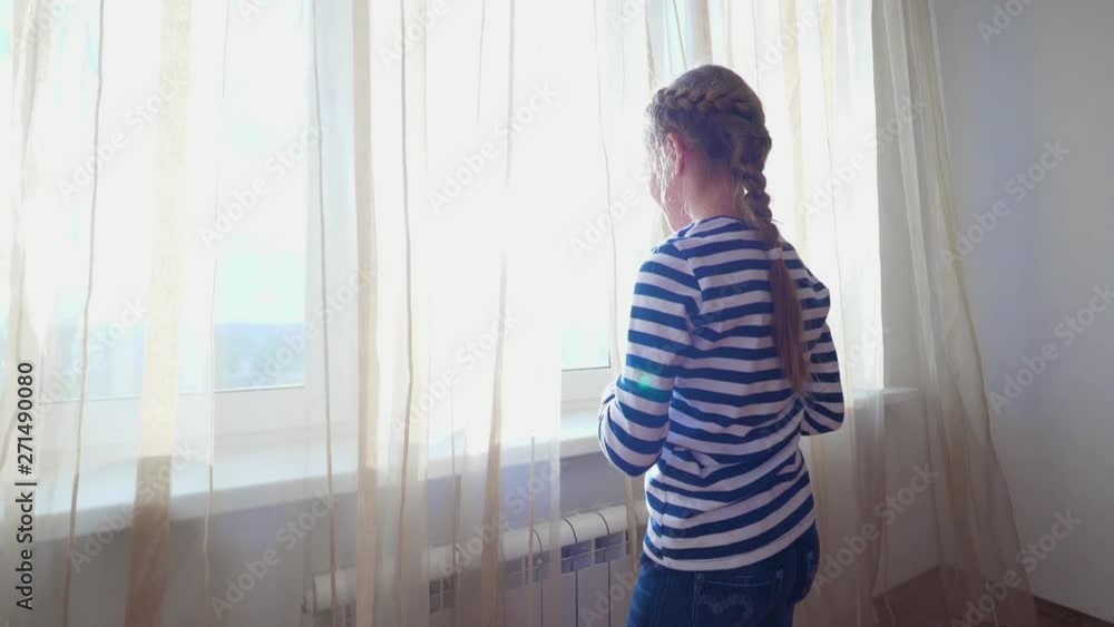 Girl unveil curtains and enjoying view. Slow motion. Girl unveil curtains and enjoying view. Slow motion.