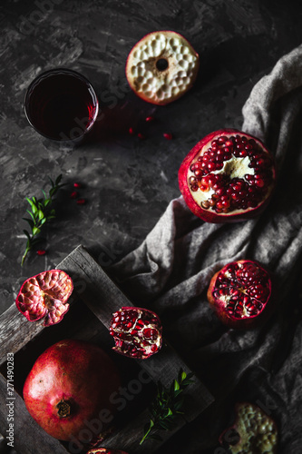 Fresh pomegranate in a wooden box. On a gray background. Top view. Copy space.