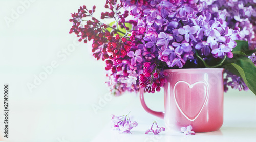 Wallpaper Mural It's spring. Fresh fragrant bouquet of lilac in a vase with a heart on a mint wooden background. Romance Torontodigital.ca