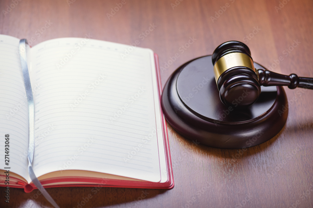 Book for records. Fair trial. Judge's wooden gavel on the table. Right to a lawyer. Judicial law. Book for records. Fair trial. Judge's wooden gavel on the table. Right to a lawyer. Judicial law.