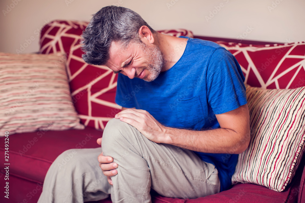 Man feels strong knee pain. People, medicine and healtcare concept Man feels strong knee pain. People, medicine and healtcare concept