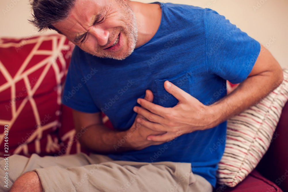 Man feels strong heart pain. People, healthcare and medicine concept Man feels strong heart pain. People, healthcare and medicine concept
