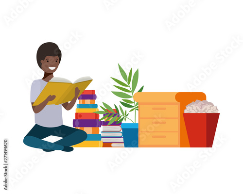 man sitting with stack of books