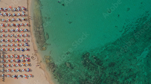 Aerial drone top view photo of turquoise organised beach forming a small heart shaped lagoon and mountainous seascape of Stavros, Chania, Crete island, Greece photo