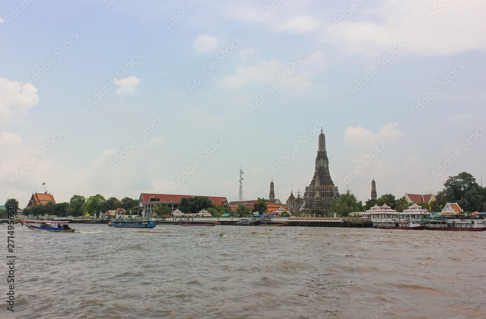 Distant view of Buddhist temple of Wat Arun Ratchawararam or Temple of Dawn in Bangkok.
