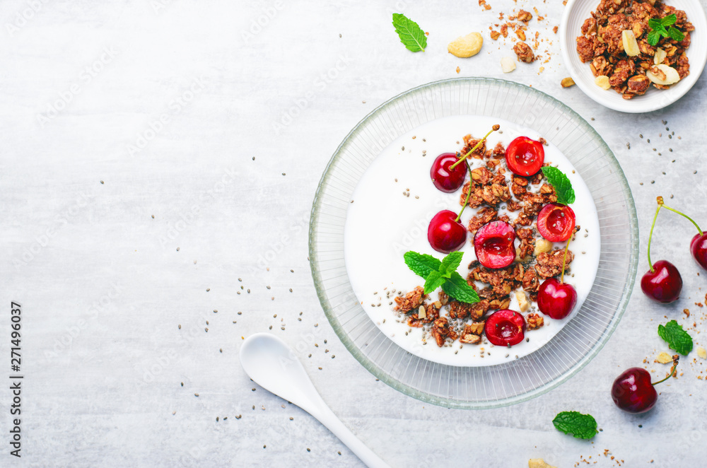 Yogurt with Cherries, Granola and Chia Seeds over Bright Background