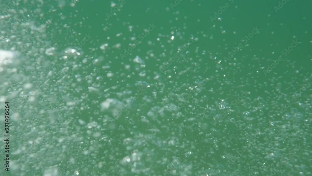 Bubbles rising to the surface. Slow motion. Air bubbles in clear blue water (underwater shot), good for backgrounds Bubbles rising to the surface. Slow motion. Air bubbles in clear blue water (underwater shot), good for backgrounds