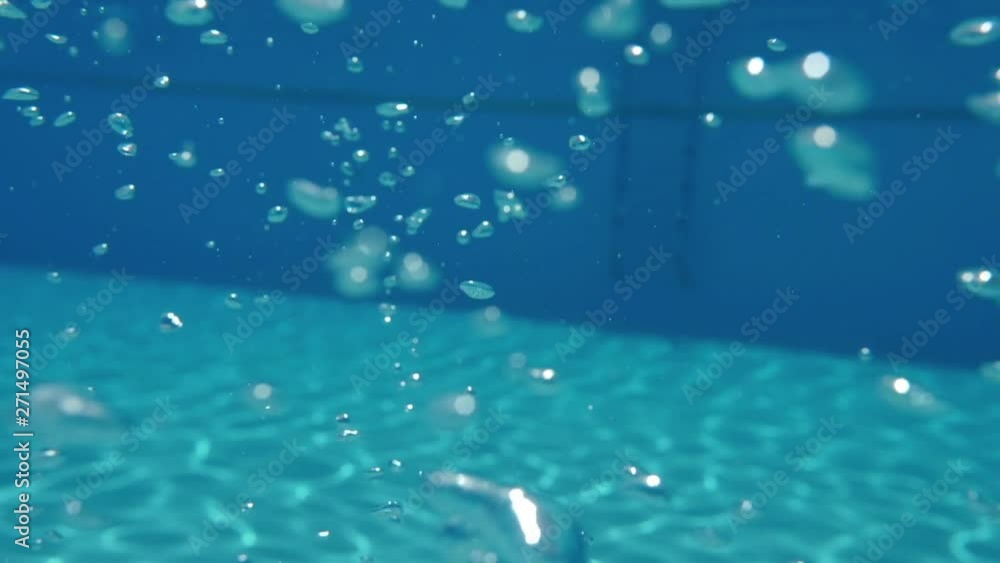 Bubbles rising to the surface. Slow motion. Air bubbles in clear blue water (underwater shot), good for backgrounds Bubbles rising to the surface. Slow motion. Air bubbles in clear blue water (underwater shot), good for backgrounds