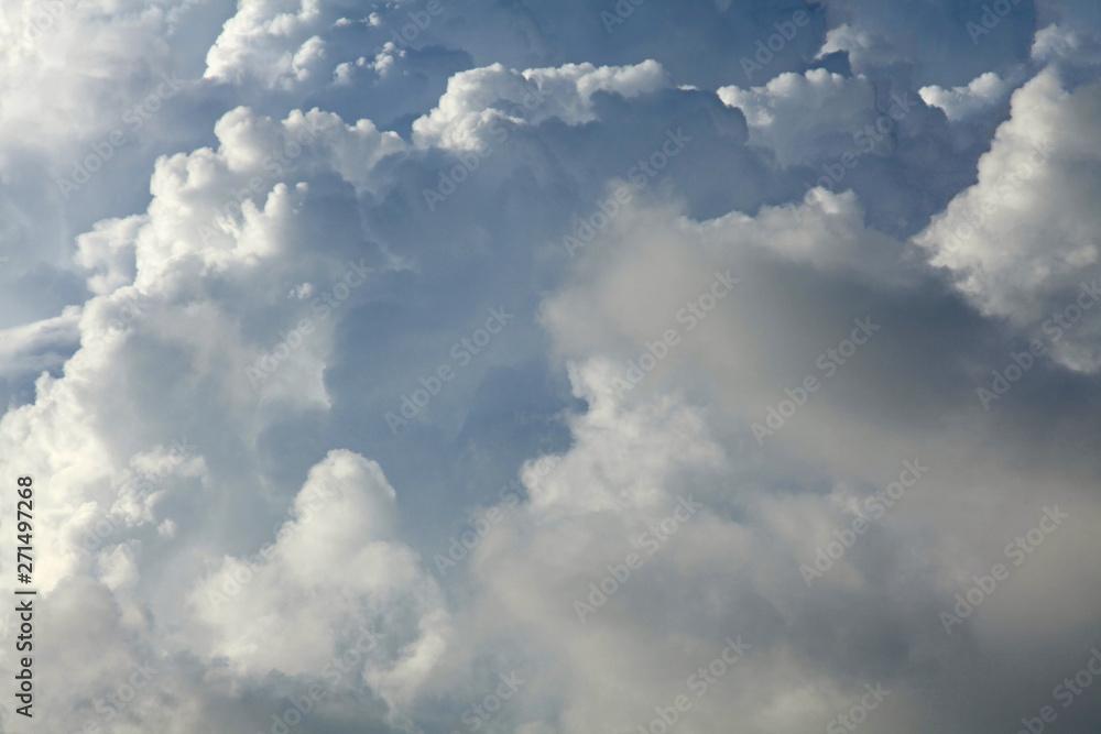 A huge cumulus and cumulonimbus clouds on the blue sky background A huge cumulus and cumulonimbus clouds on the blue sky background