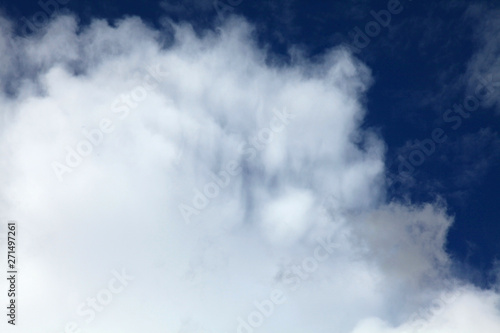 A huge cumulus and cumulonimbus clouds on the blue sky background