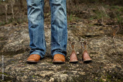 New Dad with Baby Cowboy Boots in Jeans