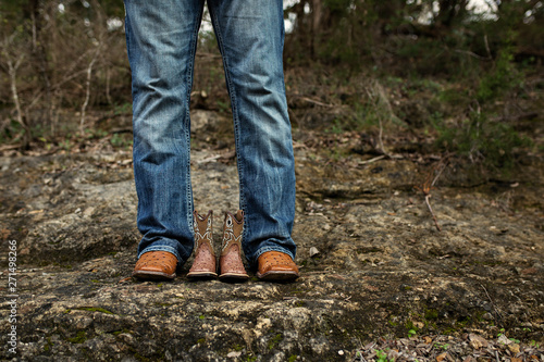 New Dad with Baby Cowboy Boots in Jeans