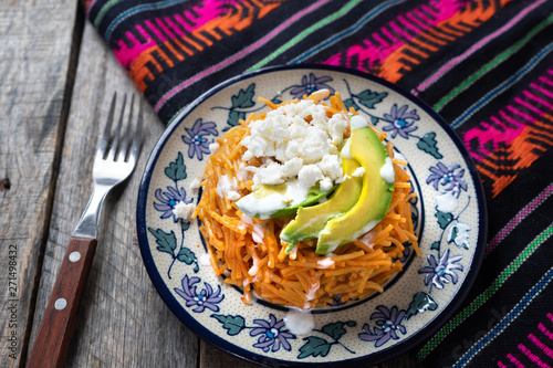 Mexican fideos dry soup with avocado and cheese photo