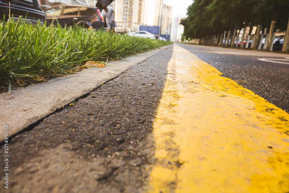 Fototapeta premium wet asphalt road with sun reflections and trees - instant vintage square photo.