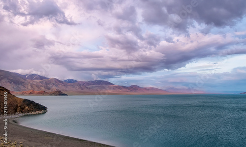 Dramatic sunset clouds above Tolbo lake. Time before sand storm. South of Olgii in western Mongolia. The photo does not contain posterization or noise. These are stormy clouds colored by sunset   photo