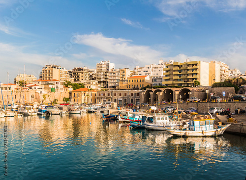 heraklion city old port view. clear day calm water boats and sky reflection on the sea beautiful colors © Petros