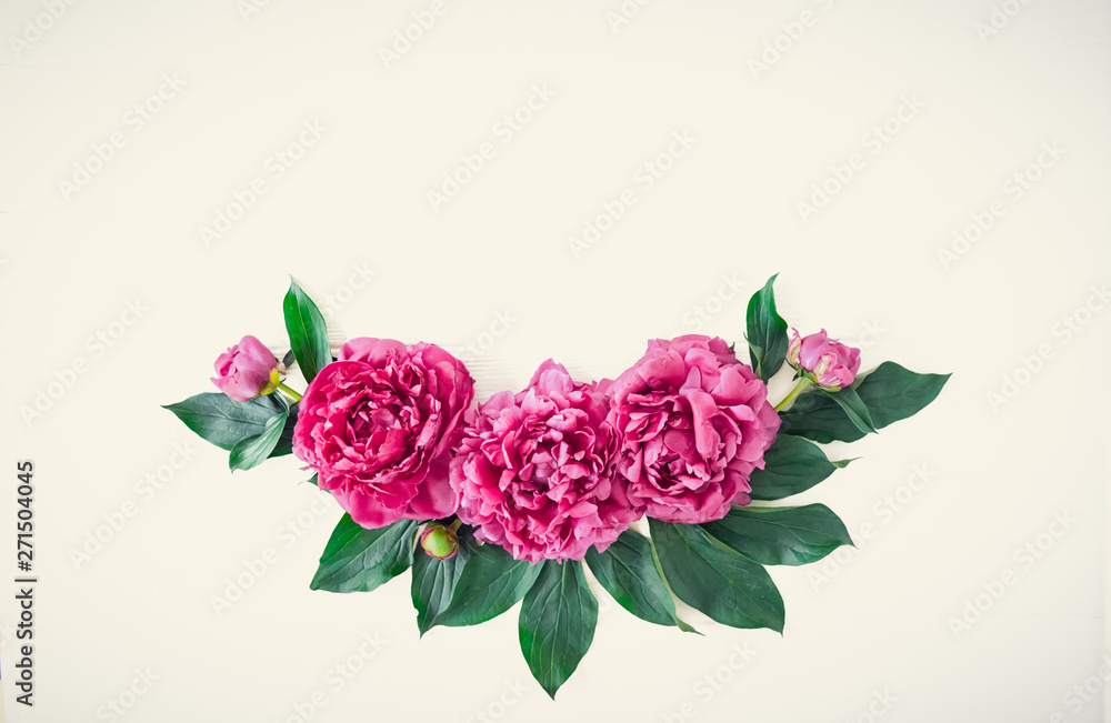 Flower border composition made of bright pink buds peony bouquet on a white wooden background. Floral texture mockup. Flat lay, top view. Peony texture. Vintage, retro toning image. Copy space.