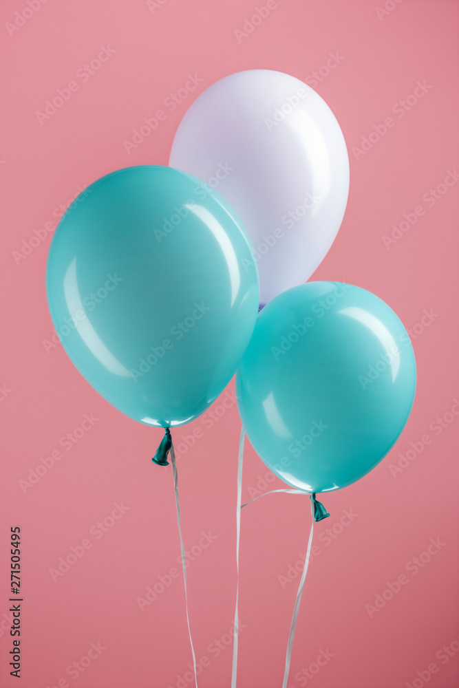 blue and purple decorative balloons on pink background