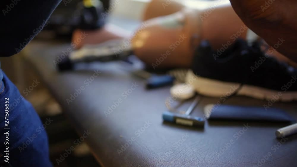 Unrecognizable professional man assembling a knee prosthesis in his workshop