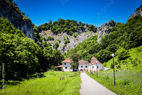 Small monastery Vratna in Serbia under the big stone, surrounded with forest