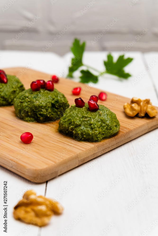 Spinach Pkhali on white wooden background, selective focus. Spinach Pkhali on white wooden background, selective focus.