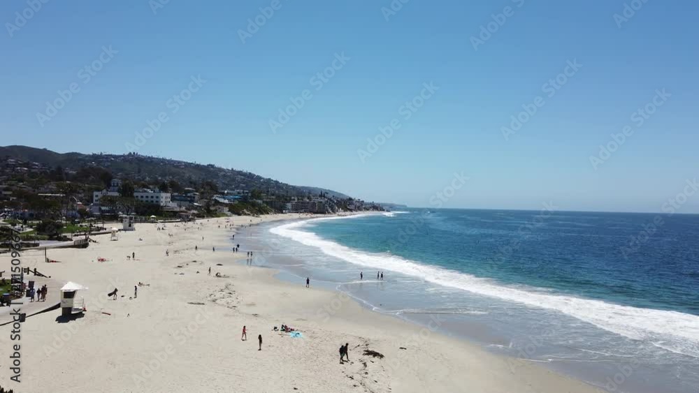 Main Beach looking south from the Inn at Laguna Beach with gentle waves and people on the sand. Main Beach looking south from the Inn at Laguna Beach with gentle waves and people on the sand.