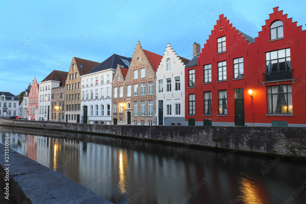 Scenic city view of Bruges canal with beautiful medieval colored houses and reflections.