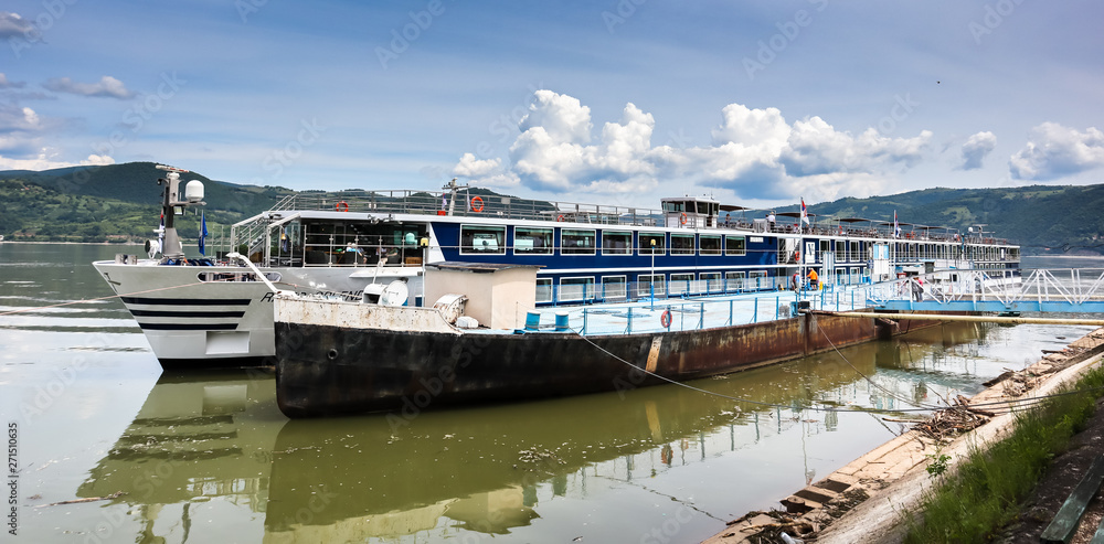 Big modern ship with tourists on the dock in Donji Milanovac by the Danube river Big modern ship with tourists on the dock in Donji Milanovac by the Danube river